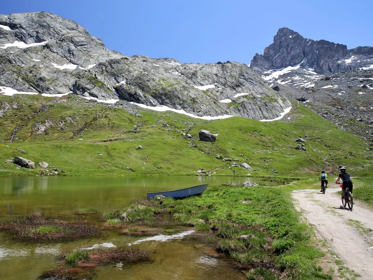 reflections in the lake at refuge de la blanche close to saint veran queyras regional natural park southern alps france with mountain bikes on the right