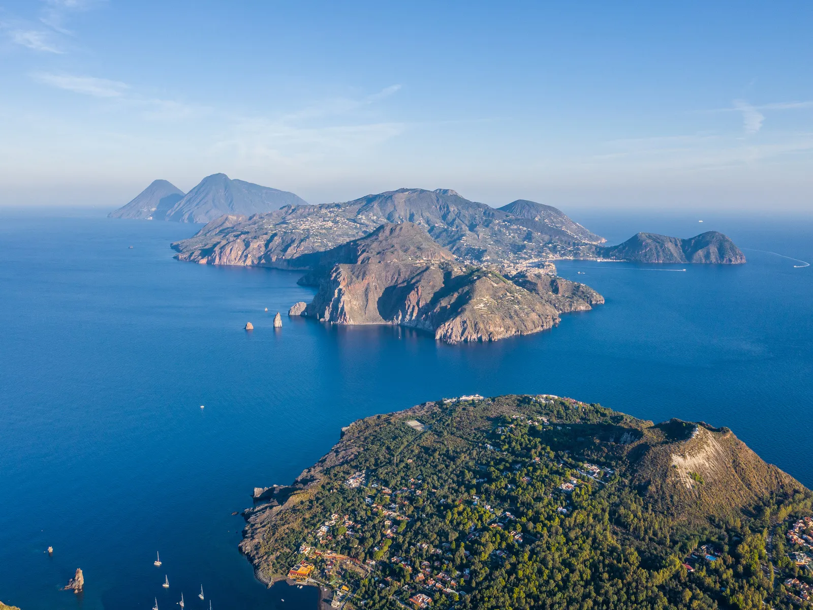 beautiful panoramic aerial view photo from flying drone on vulcano island to lipari and salina island of the aelian islands italy on a summer with blue sky
